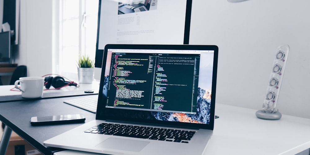Developer writing code on multiple monitors